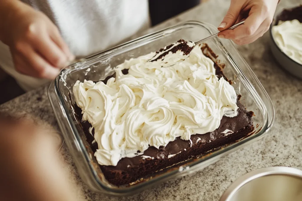 Assembling brownie and cream layers in a dish