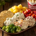 Assorted Chicken Salad Chick scoops in a tray with crackers and fruit